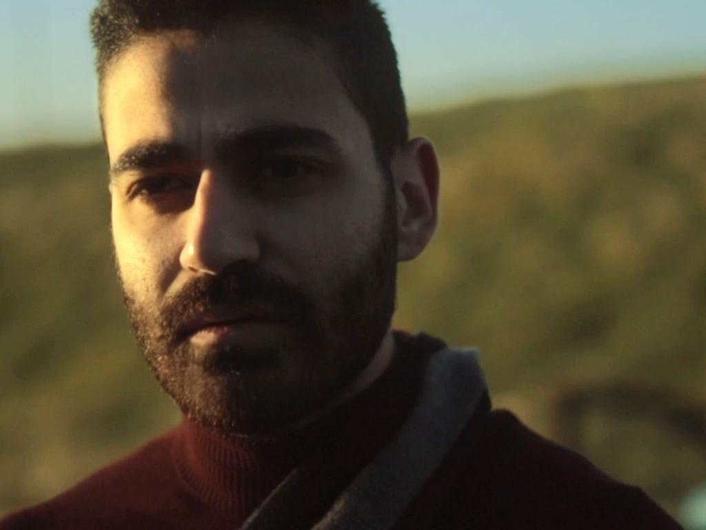 A bearded man in a red jacket at golden hour (13/13)